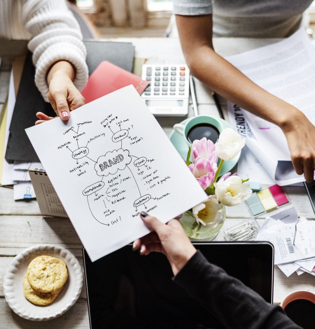 colleagues-handing-branding-plan-strategy-to-other.jpg